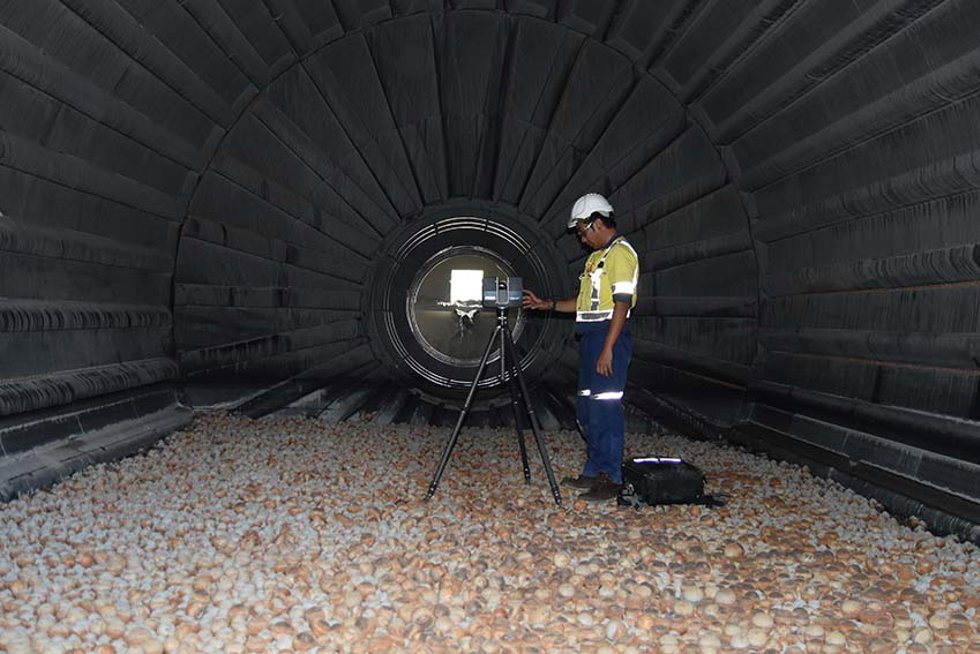 Mining engineer inside a ball mill doing measurements.