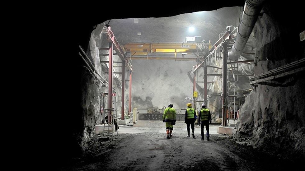 Three people pictured at an underground mine.