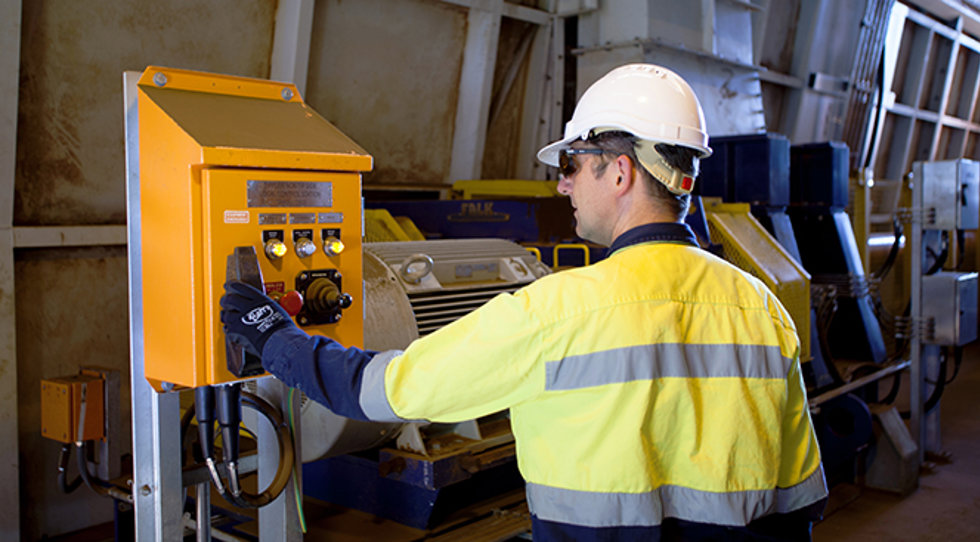 A man operating a train unloader.