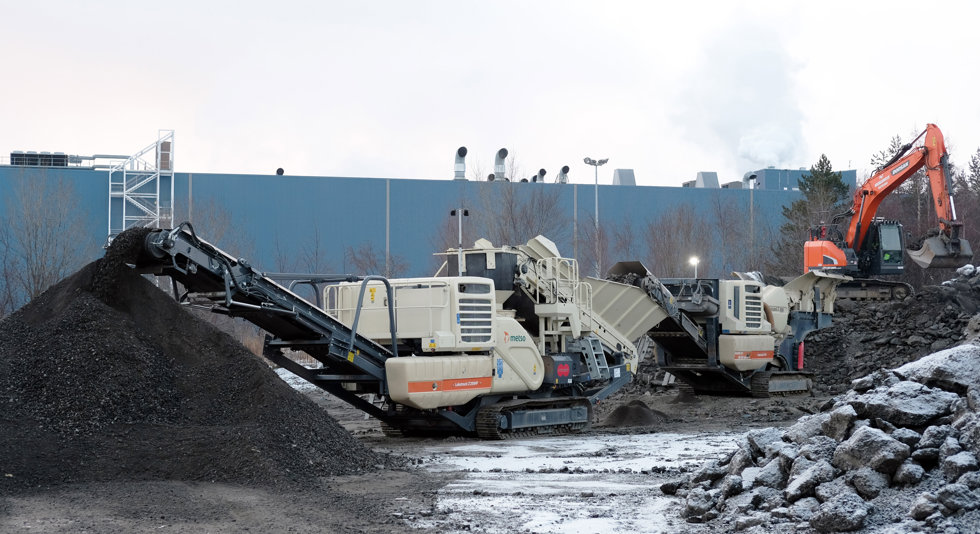 Pile of crushed asphalt and two Lokotrack units. 