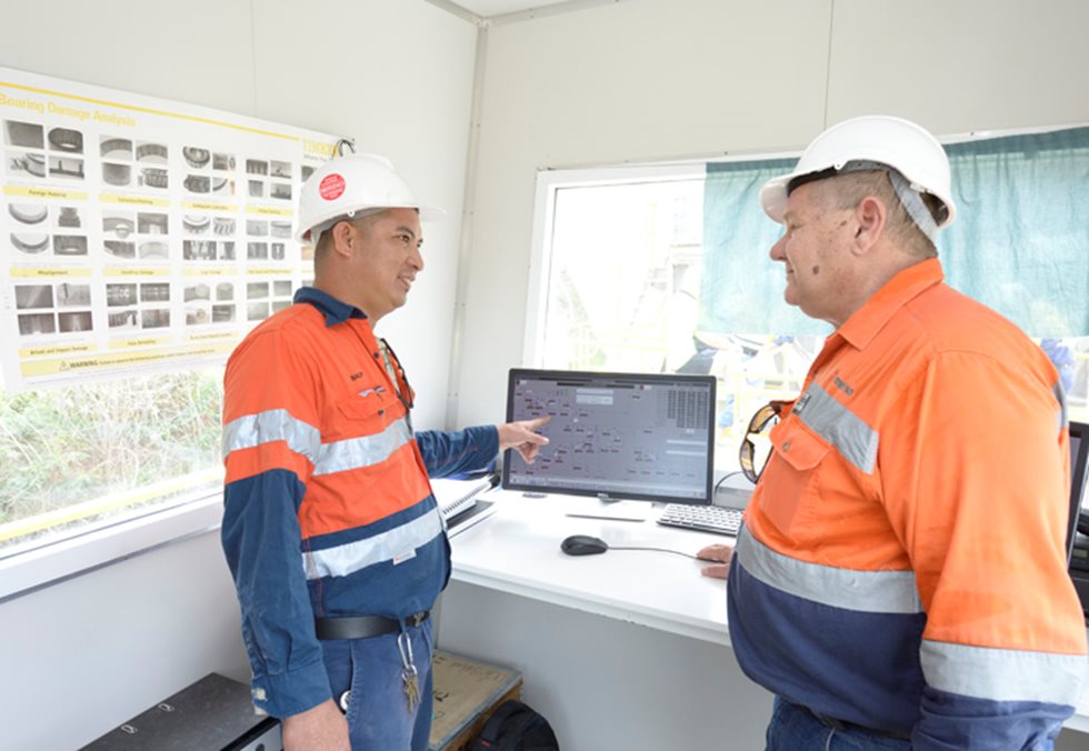 Two people talking in a control room at Monier’s Nebiri quarry.