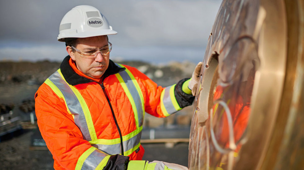 worker inspecting part closely metso repairs