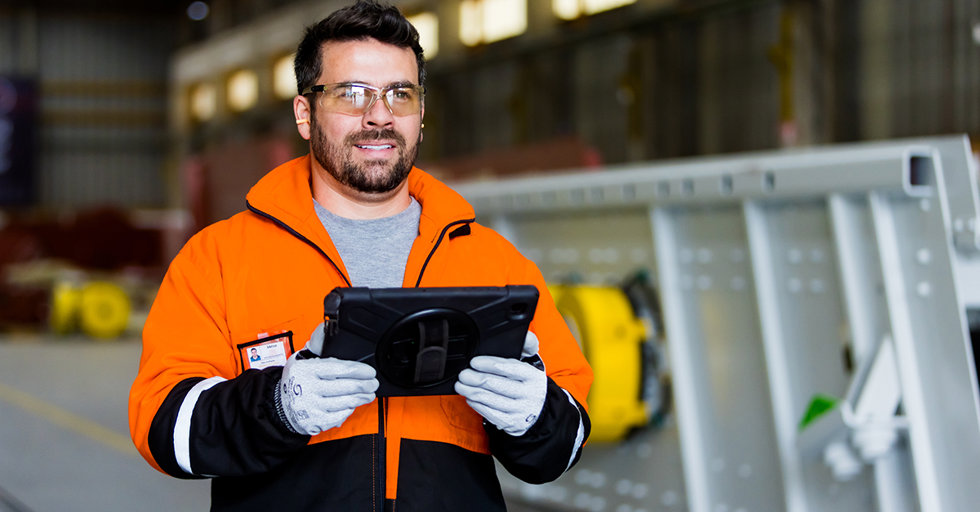 Metso services professional holding tablet