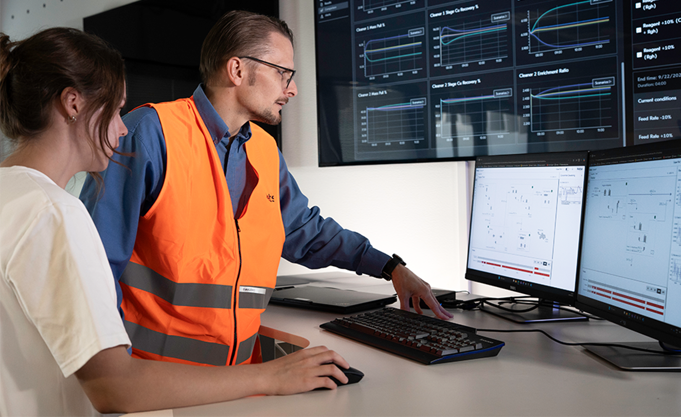 man and woman in front of metso digital production solutions