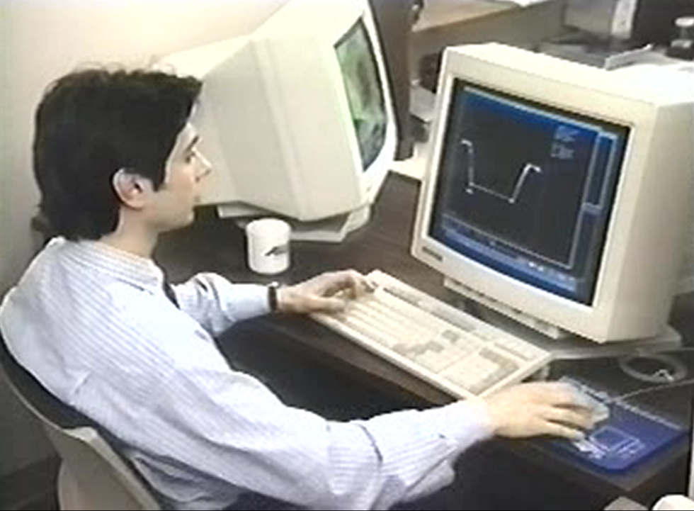 Man sitting in front of an old computer.