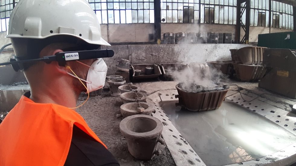 Man uses VR glasses while taking part in remote auditing at manufacturing premises.