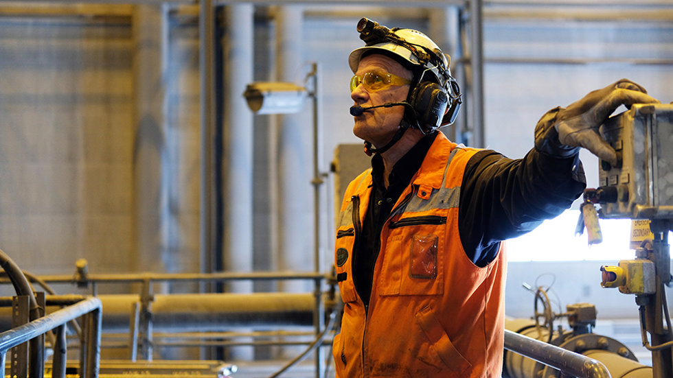 A man controlling equipment in a mine. 