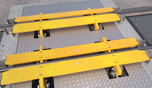 "Low profile wheel gripper for rail cars"