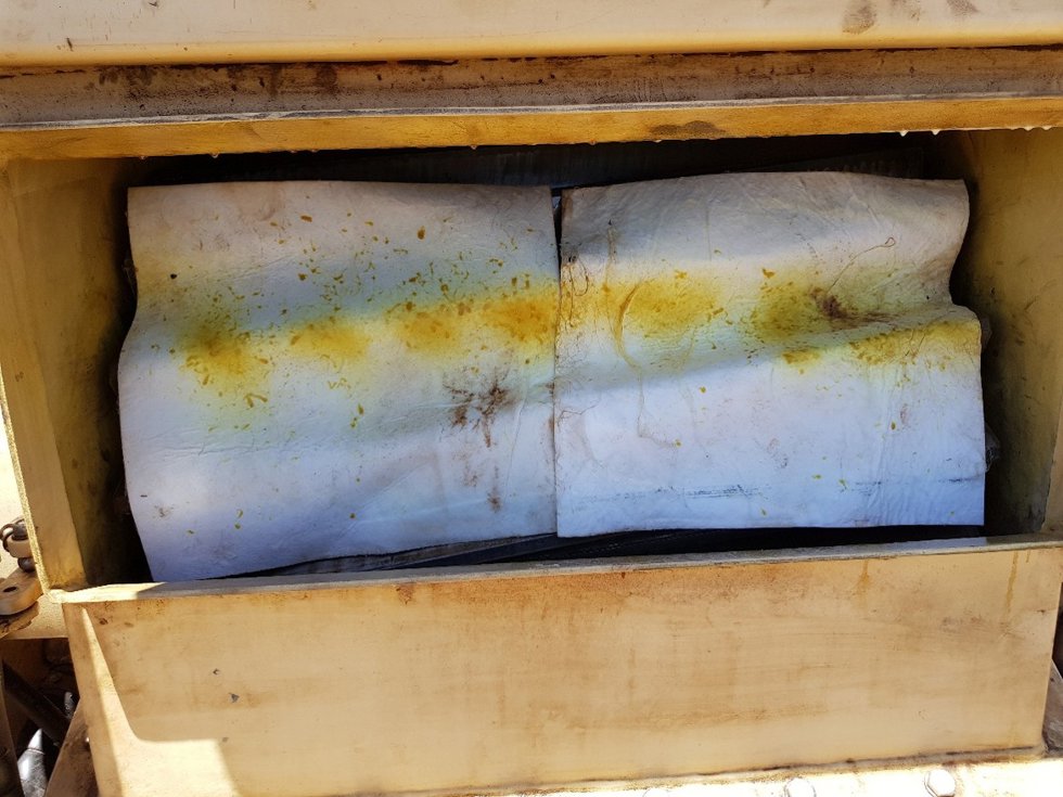 Photo showing a spray pattern test performed using white oil mats as the target.
