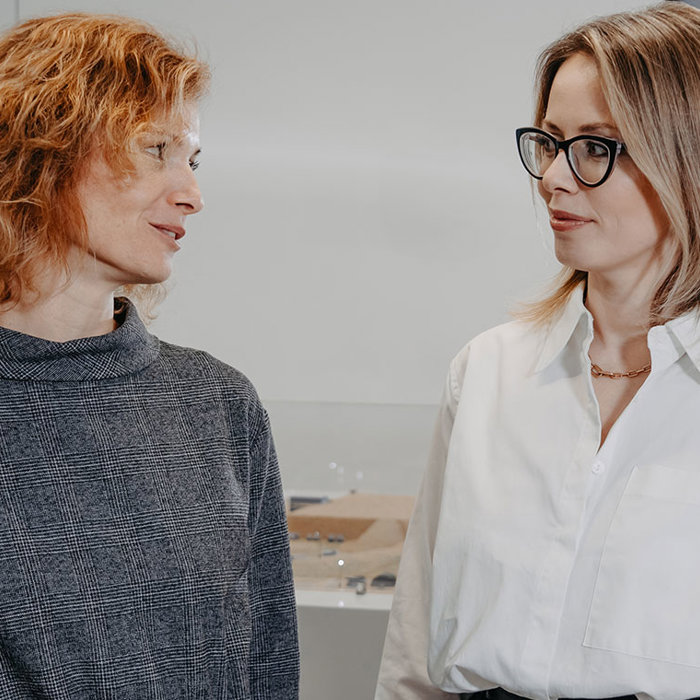 Two Metso employees discussing at an open office space.